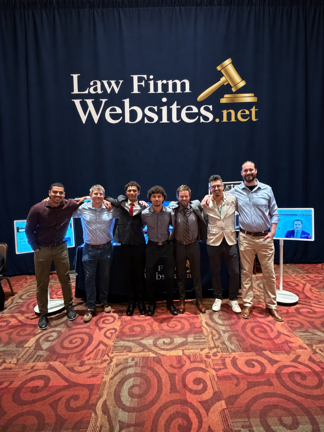 Seven people together at the State Bar of New Mexico’s 2026 Annual Convention, with an edited Law Firm Websites branded backdrop.